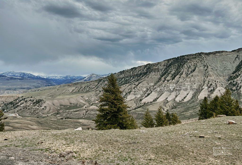 open valley and mountains along road in Yellowstone National Park